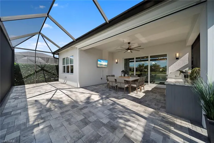 View of patio with a ceiling fan, a sunroom, and a lanai