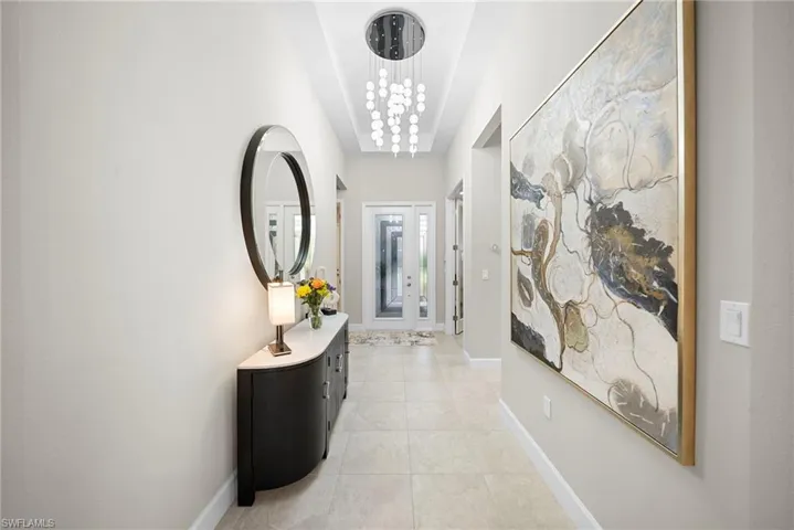 Corridor featuring hanging lights and light tile patterned flooring