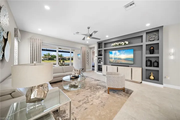Living room featuring built in features, ceiling fan, and recessed lighting