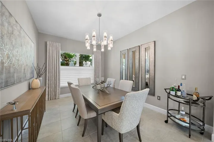 Dining area featuring suspended lighting and light tile patterned floors