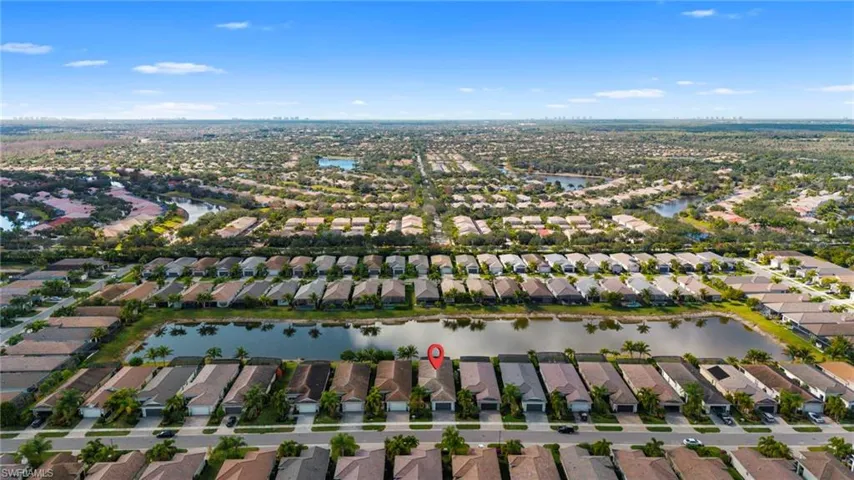 Aerial view of residential area featuring a nearby body of water