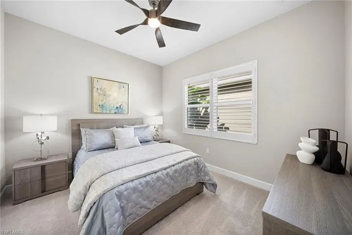 Bedroom with light carpet and ceiling fan