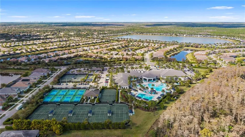 Aerial view of property and surrounding area featuring a large body of water and nearby suburban area