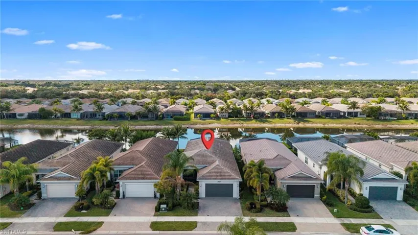 Aerial perspective of suburban area featuring a large body of water