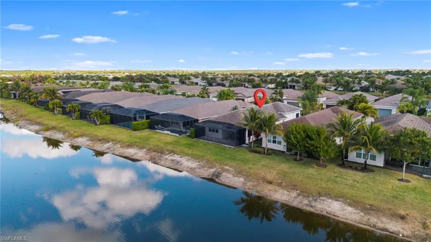 Aerial view of residential area featuring a nearby body of water