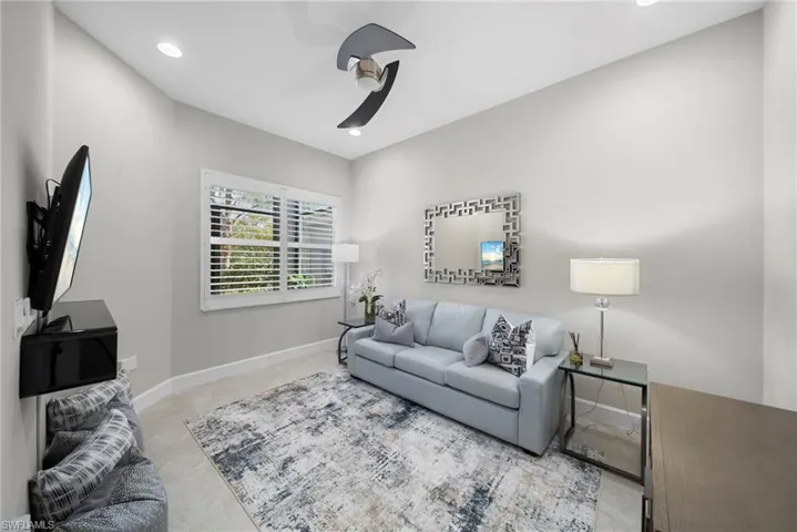 Living room with a ceiling fan and recessed lighting