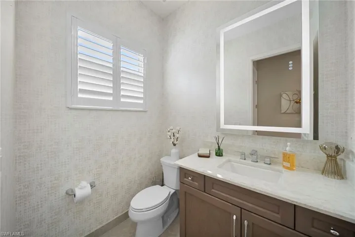 Half bathroom with vanity and toilet