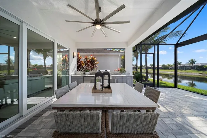 View of patio with a lanai, a sunroom, a residential view, and a water view ROOM FOR A POOL!