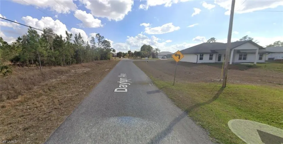 View of asphalt road with traffic signs