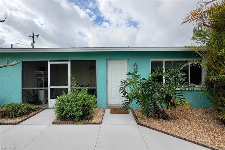 Doorway to property with stucco siding