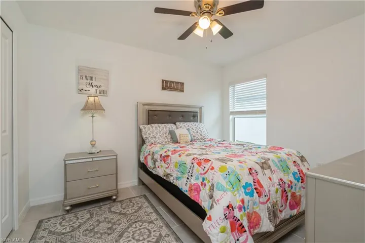 Tiled bedroom with ceiling fan