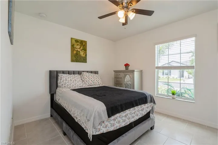Tiled bedroom with ceiling fan