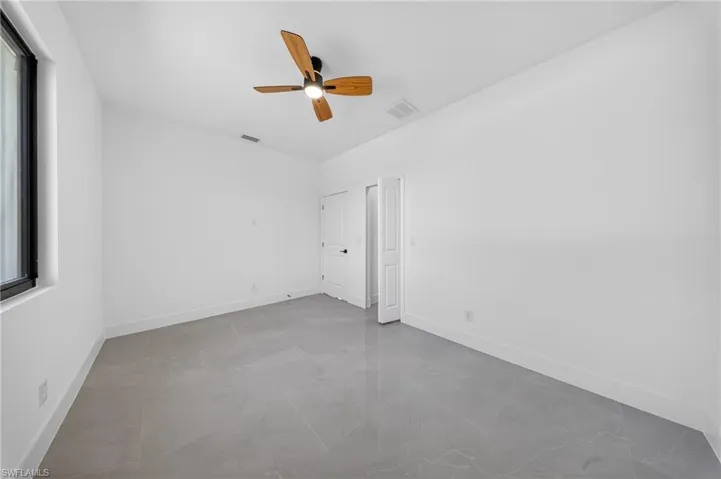 Unfurnished bedroom featuring ceiling fan and baseboards