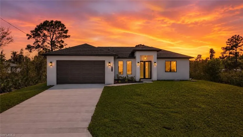 Contemporary single-story residence with a dark brown garage door and matching roofline