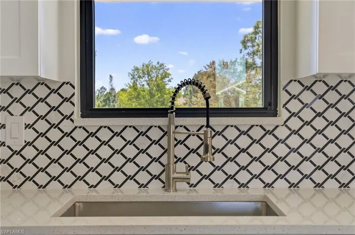 Kitchen view of light stone countertops and white cabinets