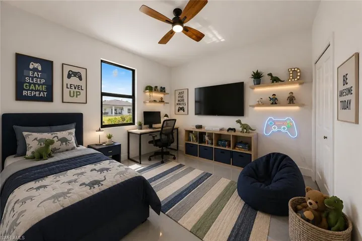 Bedroom featuring a large window, a wood-finish ceiling fan, built-in wall shelving with integrated lighting, a built-in media console, and a solid core door