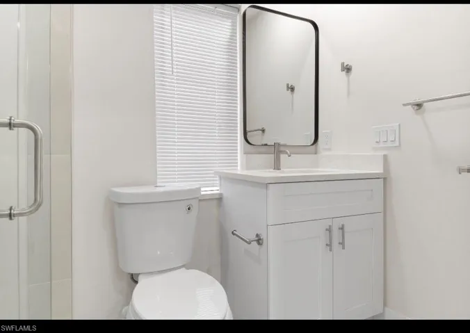 Bathroom with vanity and a shower stall