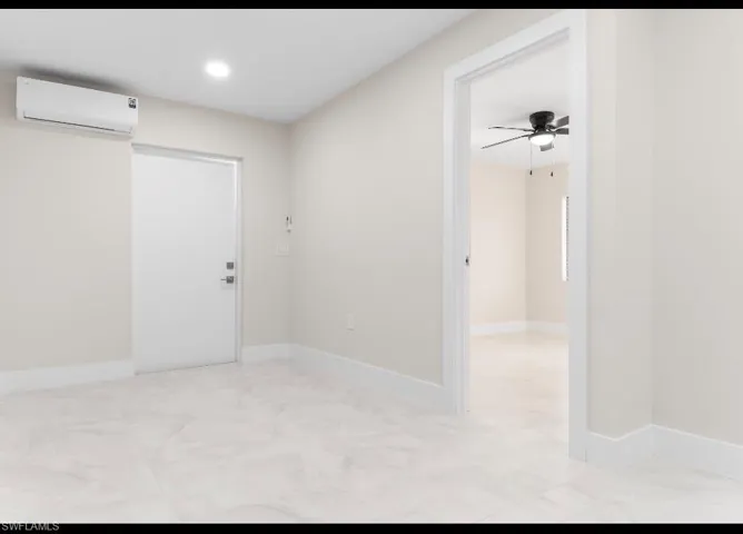 Unfurnished room with a wall unit AC, a ceiling fan, and recessed lighting