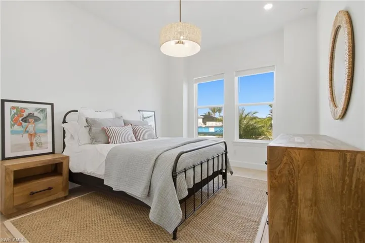 Bright interior with two windows, a semi-flush mount light fixture, and recessed lighting
