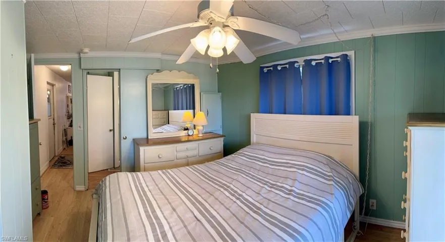 Bedroom with, crown molding, a closet, and ceiling fan