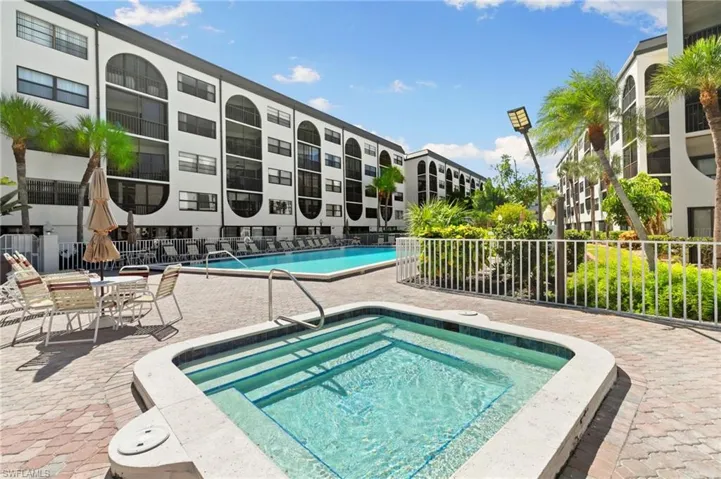 Community pool with a hot tub and patio area