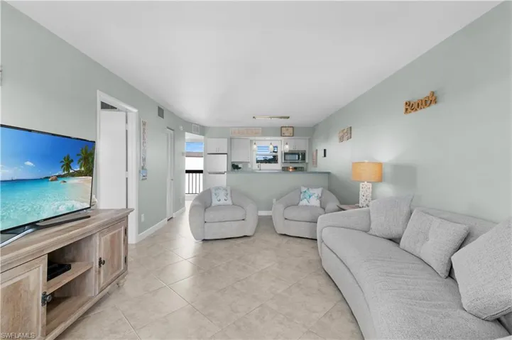 Living room featuring light tile patterned floors and baseboards