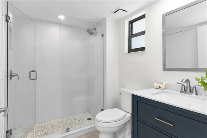 Spacious bathroom remodeled in 2020, navy blue vanity, dimmable lighting