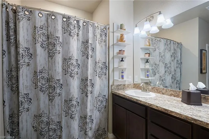 Full bath featuring vanity and a shower.