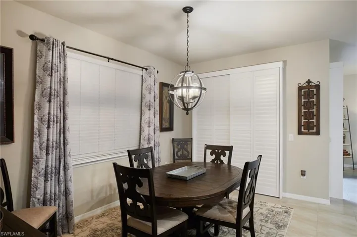 Dining area featuring a chandelier and light tile patterned floors