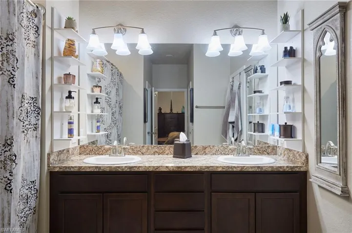 Ensuite bathroom with double vanity and a chandelier