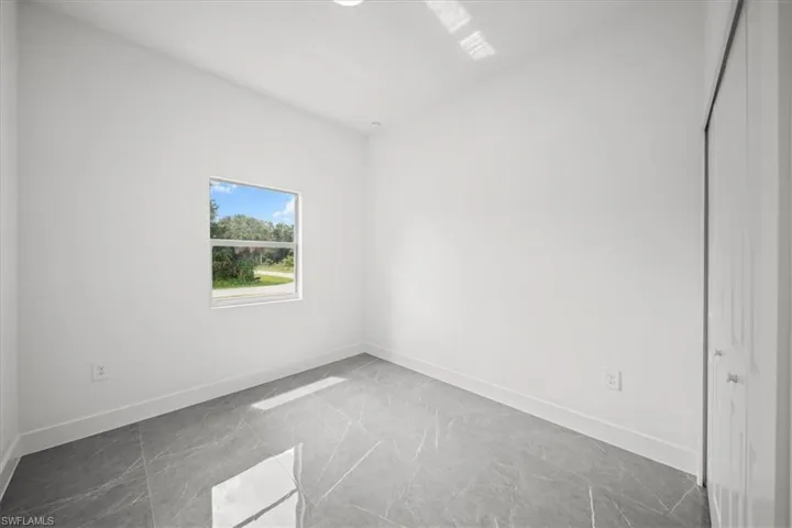 Unfurnished room with baseboards