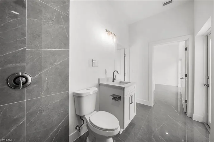 Bathroom with marble tiled floors and vanity