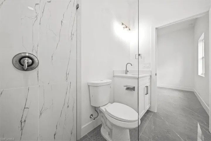 Bathroom with vanity and marble look tile flooring