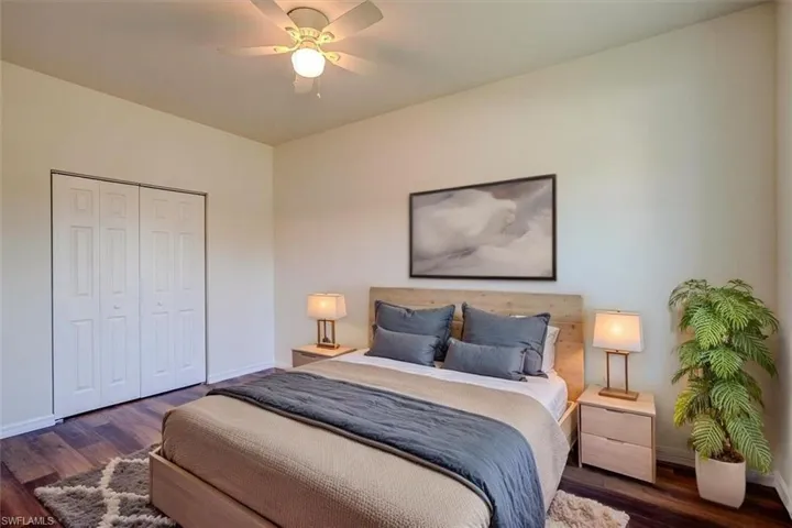 Bedroom featuring wood finished floors, baseboards, and a closet