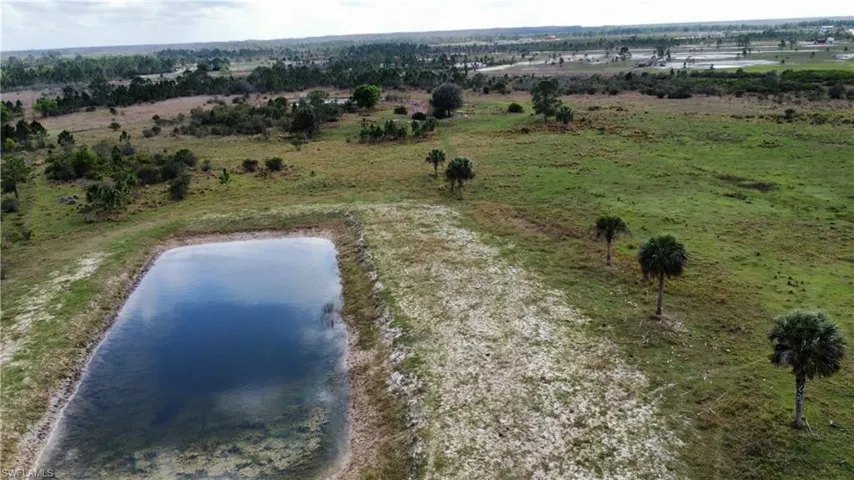 Drone / aerial view featuring a water view and a rural view