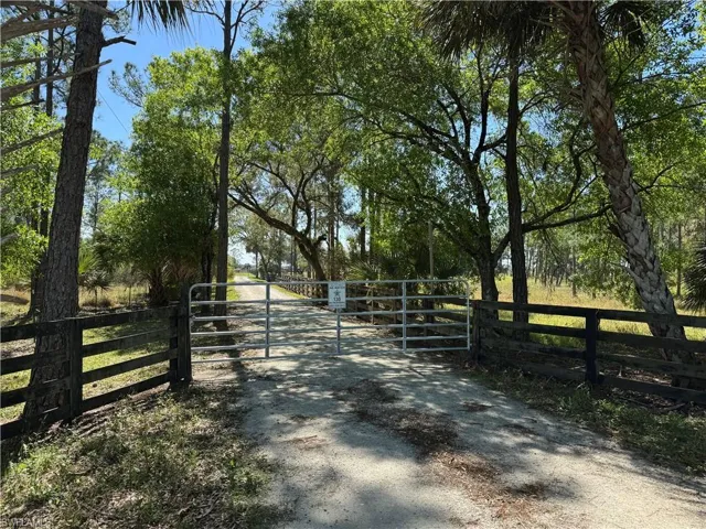 View of gate with a rural view