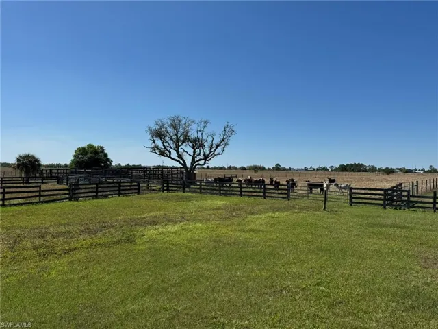 View of yard featuring a rural view and fence