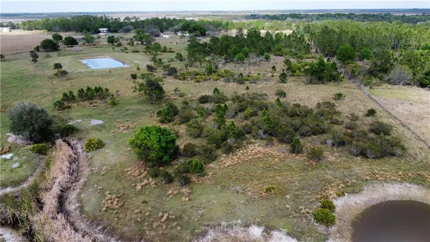 Drone / aerial view featuring a water view and a rural view
