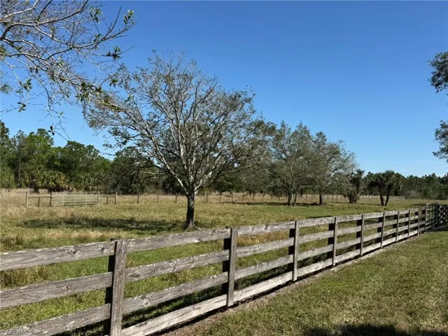 View of yard featuring fence and a rural view