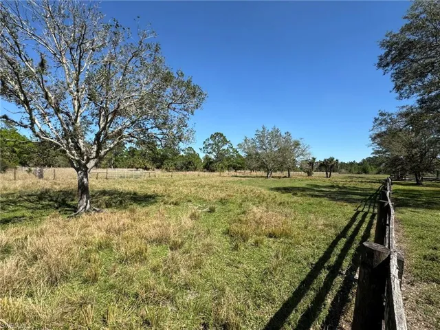 View of yard featuring a rural view and fence