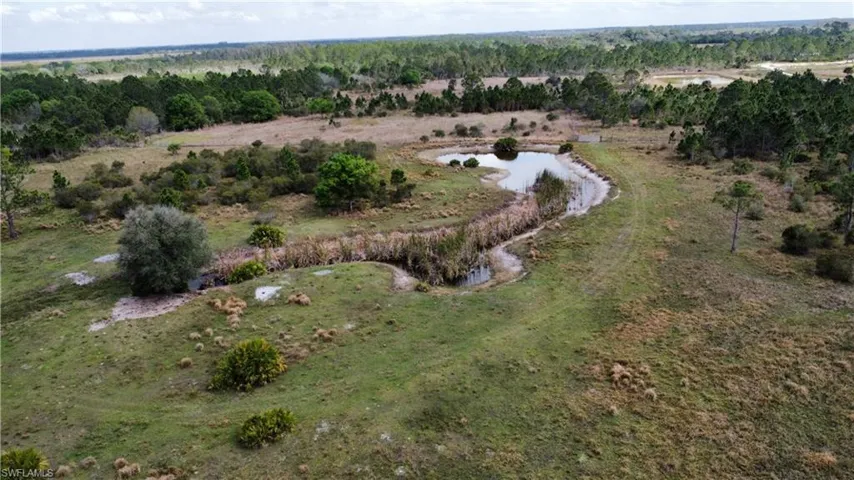 Birds eye view of property featuring a rural view and a water view