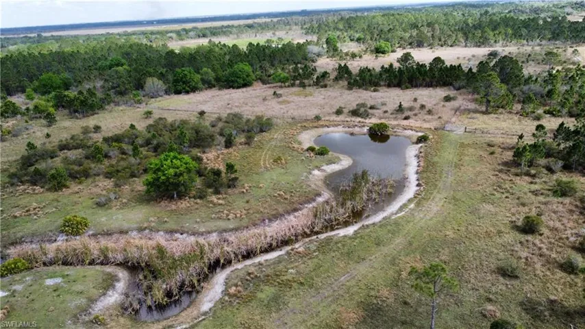 Birds eye view of property with a water view