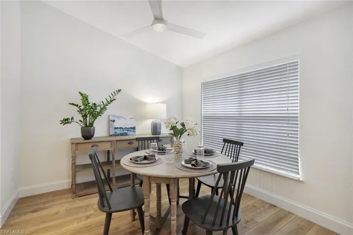 Dining space features  an abundance of natural light, contemporary light wood-style flooring and ceiling fan. This versatile space can also be used as a den