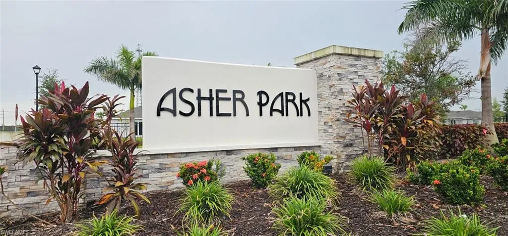 Asher Park signage featuring stacked stone and lush landscaping