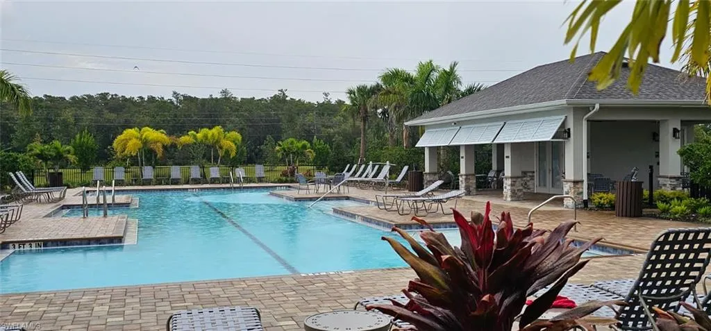 Expansive swimming pool with integrated spa, surrounded by a paver deck