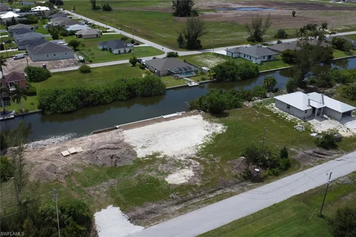Birds eye view of property with a water view