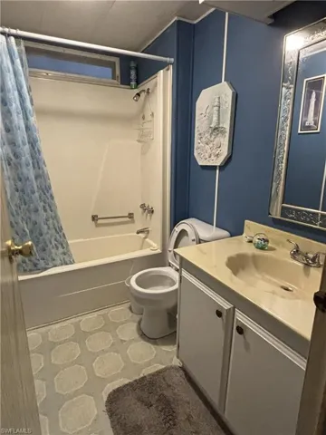 Guest full Bathroom with vanity and shower / tub combo with curtain