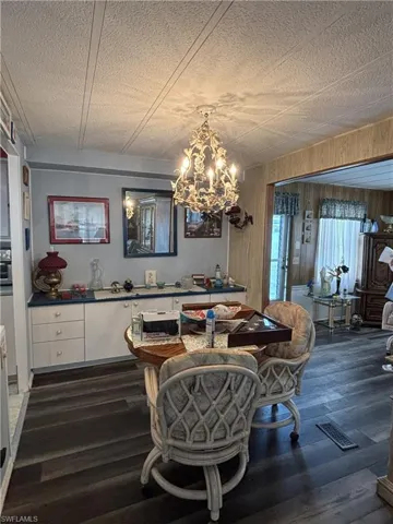 Dining/family room combo, beautiful chandelier, vinyl flooring.