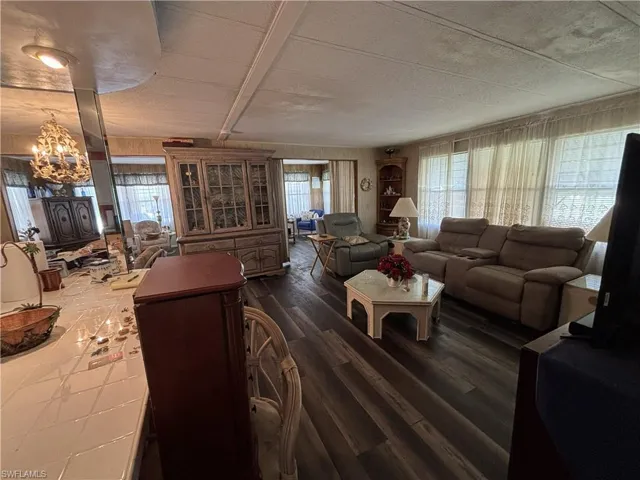 Family room just off of the kitchen features lots of windows & vinyl wood look floor panels.