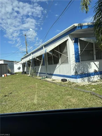 View of home's exterior with a yard